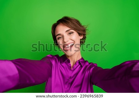 Photo of positive optimistic glad girl wearing stylish pink clothes celebrating holiday shooting isolated on green color background