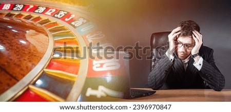 Man lost at casino. Roulette is game of chance. Guy is gamer sitting clutching head. Man went bankrupt due to gambling addiction. Gambling addict lost money. Casino addiction. Upset gambling addict Royalty-Free Stock Photo #2396970847