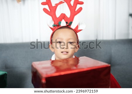 Merry Christmas 2024 concept Boy receives a gift from his mother at christmas