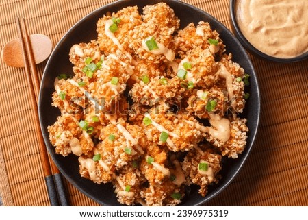 Bang Bang Chicken crispy bites and spicy sauce that will wow your taste buds closeup on the plate on the table. Horizontal top view from above
 Royalty-Free Stock Photo #2396975319