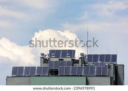 Photovoltaic, solar panels on the roof of a residential block. Production of electricity by prosumers using solar energy. Photo taken during the day, natural lighting conditions