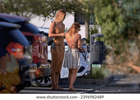 Two young women on the road with a mobile phone in their hands