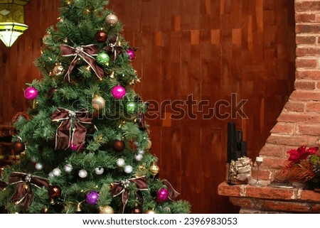 Background of a wooden house or cabin with a Christmas tree next to a chimney