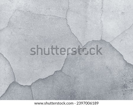 Cracks in concrete walls create the image of mountains beneath the walls this area is darker.