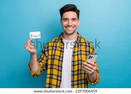 Photo of good mood funny guy wear yellow checkered shirt online shopping modern device isolated blue color background