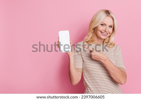 Photo of attractive person indicate finger hand hold empty space smart phone screen isolated on pink color background
