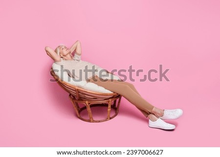 Full size photo of calm satisfied aged person sit cozy chair hands behind head sleep isolated on pink color background
