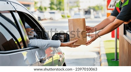 Woman getting fast food at drive-thru