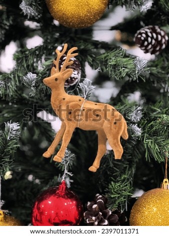 Cute deer decorates the Christmas tree.