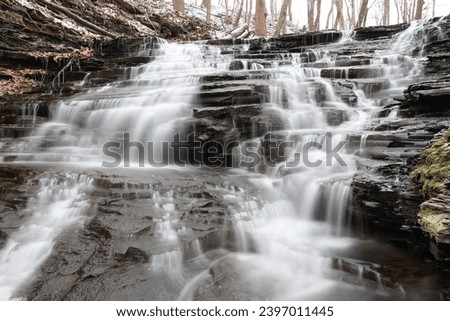 Winter waterfall long exposure in forest