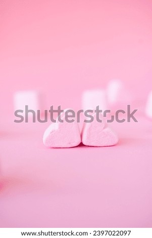 sweet heart shape of marshmallows on pink background. Decoration for love and valentine day concept.