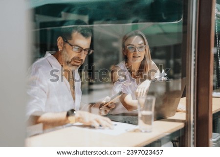 Multicultural business team discussing ideas and analyzing statistics for better results and corporate growth. Royalty-Free Stock Photo #2397023457