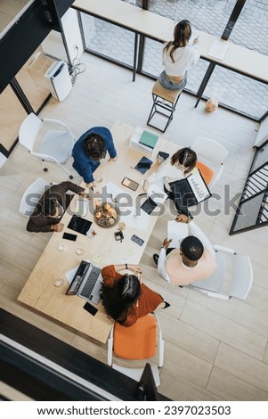 Colleagues discussing business solutions, growth hacking, and product development. Networking with clients support for profit growth. Cross-generational teamwork for productivity. Royalty-Free Stock Photo #2397023503