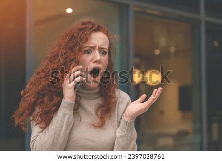 Portrait of a young woman talking in anger on her mobile to her boyfriend about ending their relationship toned image