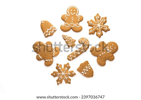 Christmas homemade gingerbread cookies of a man, snowflake, bell, star and tree with icing isolated on white background