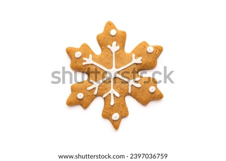 Christmas Gingerbread cookie of a snowflake with icing isolated on white