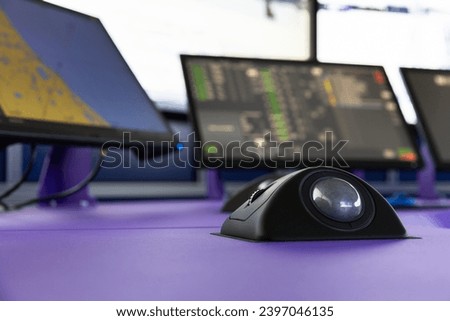 Modern ship control panel with digital screens and built-in trackball Royalty-Free Stock Photo #2397046135