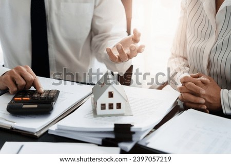 Home loan insurance. 
Real estate broker and client sign contract insurance agreement document. Business meeting concept