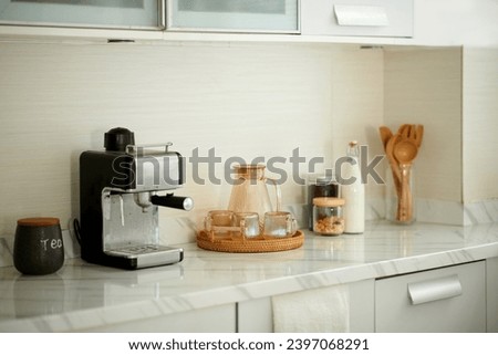 Coffee station at home with jar of water, bottle of milk and coffee machine Royalty-Free Stock Photo #2397068291