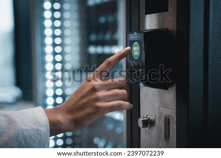 Close up hand of woman pushing button on vending machine for choosing a snack or drink. Small business and consumption concept. Royalty-Free Stock Photo #2397072239