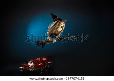 Italian Epiphany day tradition. Witch Befana flying on broomstick, moon light, Christmas sweets and sweet coal Royalty-Free Stock Photo #2397074159