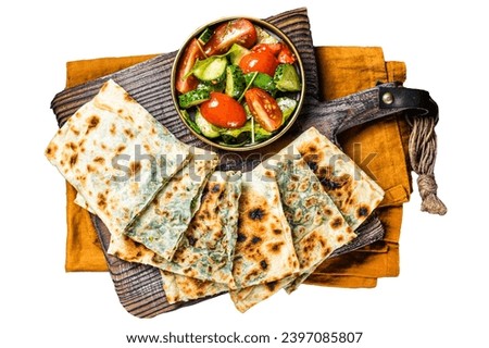 Freshly baked Turkish Gozleme, flatbread with greens and cheese.  Isolated, white background Royalty-Free Stock Photo #2397085807