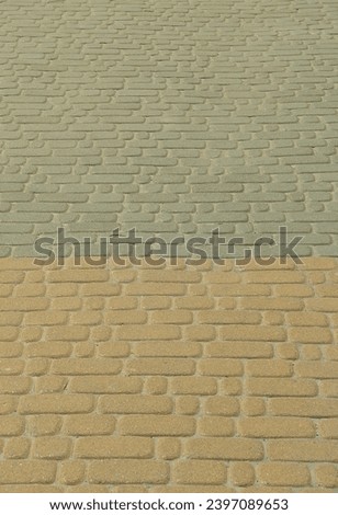A detailed photo of the square, laid out of modern paving stone with rounded corners. Accurate design of pedestrian areas
