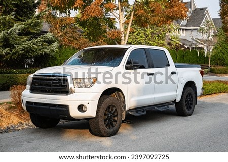 Four door pickup truck. Sport model modern and powerful car. White pickup truck on the road, Side View, nobody Royalty-Free Stock Photo #2397092725