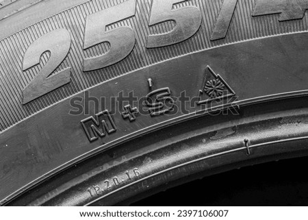 Tire side view with M plus S and 3PMSF marking or Mud and Snow and Three Peak Mountain Snow Flake symbol Royalty-Free Stock Photo #2397106007