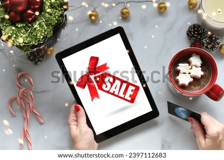 Female shopping holiday sales online tablet computer, mobile device