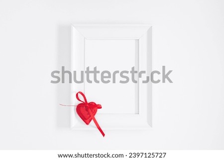 Elegant composition for Valentine's Day. Photo frame, red hearts on white background. Valentine day concept, design. Flat lay, top view, copy space