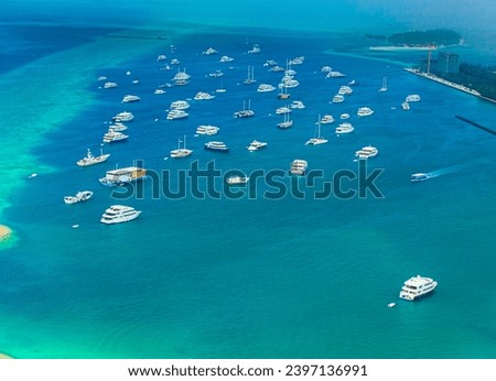 An aerial view of a group of boats anchored in the Indian Ocean, Maldives