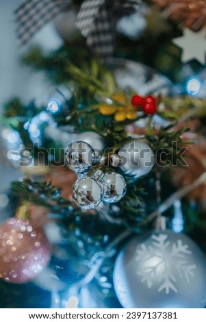 sparkling Christmas tree ornament snow globes on a background of decorative lamps