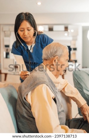 Vertical close-up of a home nurse checking the heartbeat of a old man Royalty-Free Stock Photo #2397138713