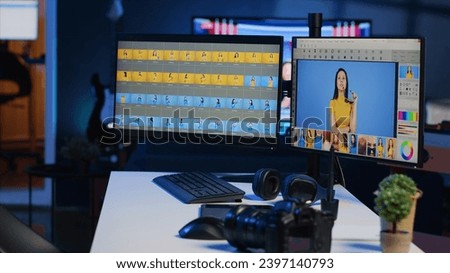 Freelancer personal studio desk with computer screens used for photo processing, graphic tablet and professional camera. Photography gear on table used by photographer, panning shot