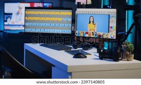 Modern creative office in media agency with multi monitor computer setup used for image retouching. Professional post processing photography studio with editing software interface on PC screens