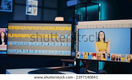 Empty media agency office with multi monitors setup used for post processing image color grading. Editing software interface on desktop PC in specialized graphic design creative studio