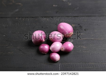 Bawang Merah or Shallots or Red Onion on wooden dark background. Selective Focus. Top View.