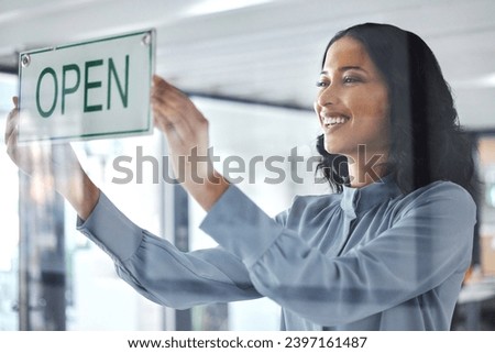 Woman, open sign and window store for business hours as professional owner, entrepreneur for customer notice. Female person, smile and holiday information for sales poster, service news for welcome