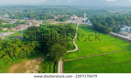 Aerial drone shot of green cultivated land scenery at Kampung Parit Melana in Durian Tunggal, Melaka, Malaysia