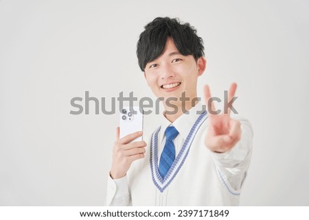 Asian high school boy with the smartphone peace sign gesture in white background