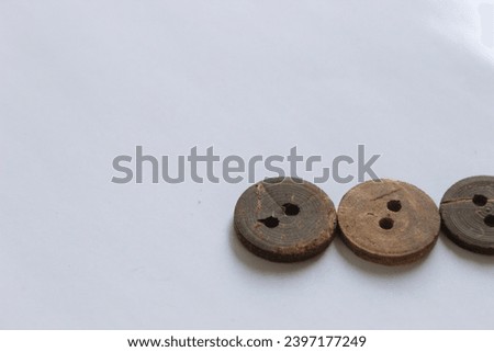 Buttons, needles on a white background and isolated