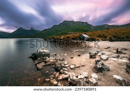 a slow shutter speed photo of Dove lake and Cradle Mountain taken at sunset