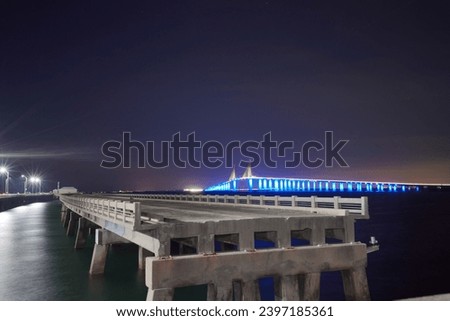 Night landscape of Skyway Fishing Pier State Park is a Florida State Park. The old broken collapsed bridge were left in place and converted into the longest fishing pier in the world. Royalty-Free Stock Photo #2397185361