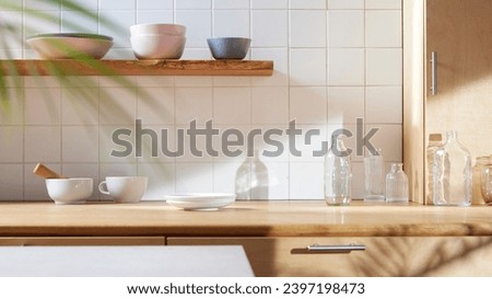 A sunny kitchen with white tile walls, a wooden table and sink. Royalty-Free Stock Photo #2397198473