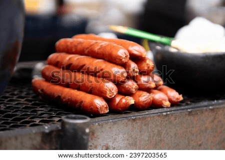 close-up of some Colombian chorizos to be prepared with arepas on the street. Colombian fast food concept Royalty-Free Stock Photo #2397203565