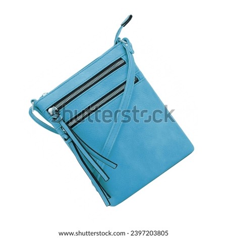 Small blue leather haversack backpack bag. Wallet with adjustable shoulder or wrist handle. Pockets with ample storage capacity, ideal for agendas, cell phone, storing personal items isolated on white Royalty-Free Stock Photo #2397203805