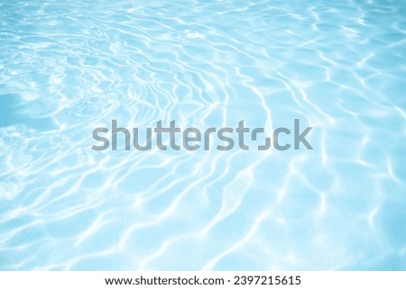Water background, ripple and flow with waves. Summer blue swimming pool pattern. Ripple Water in swimming pool with sun reflection