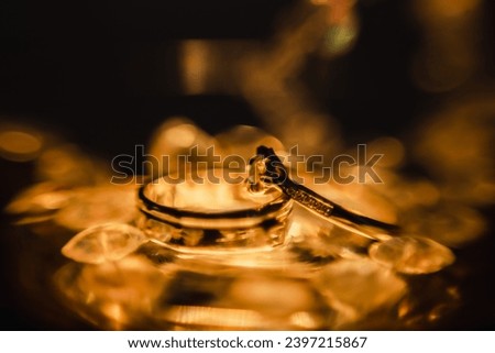 Wedding rings placed together in a golden yellow glow symbolize a prosperous future in love.
