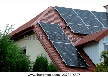 Installing a Solar Cell on a Roof. Solar panels on roof. Historic farm house with modern solar panels on roof and wall. High quality photo Royalty-Free Stock Photo #2397216827